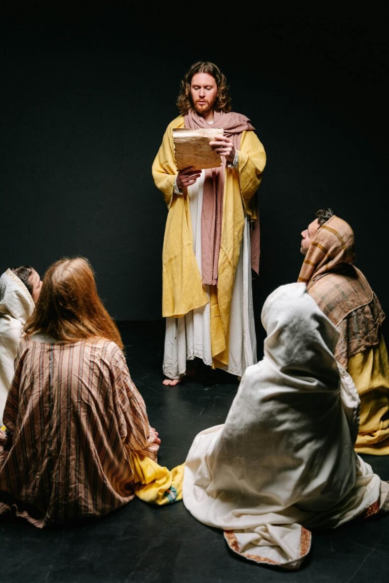 Jesus reading to a group of apostles in traditional attire, illustrating a biblical scene.